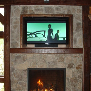 TV mounted over fireplace in outdoor area