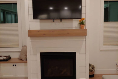 Example of a cottage living room design in Boise with a wall-mounted tv