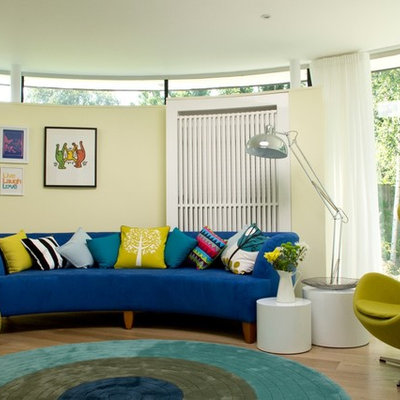 Living room - large contemporary medium tone wood floor living room idea in London with beige walls