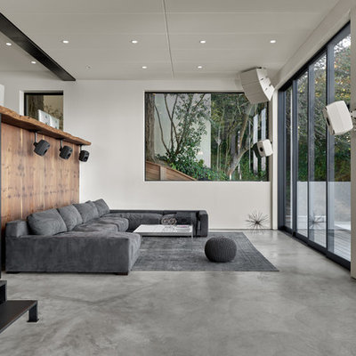 Living room - large modern open concept concrete floor and gray floor living room idea in San Francisco with a bar and white walls