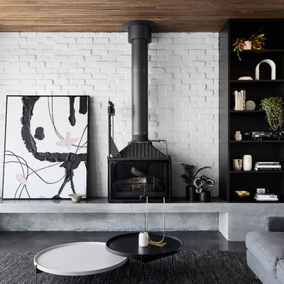 Living room - large contemporary open concept concrete floor and gray floor living room idea in Melbourne with white walls and a wood stove