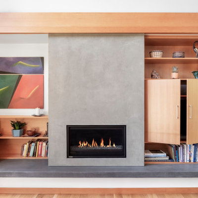 Living room - contemporary open concept light wood floor and beige floor living room idea in Portland with white walls, a standard fireplace and a concealed tv