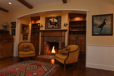 Inspiration for a mid-sized timeless formal and enclosed dark wood floor and brown floor living room remodel in Boston with beige walls, a standard fireplace, a brick fireplace and no tv