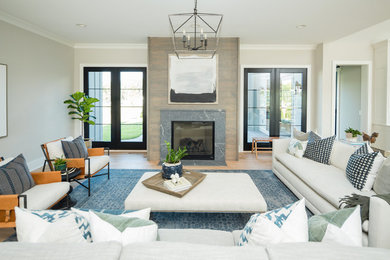 Living room - transitional living room idea in Columbus with gray walls, a standard fireplace and a wood fireplace surround