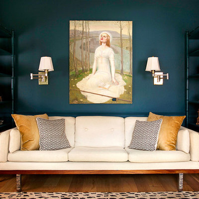Example of an eclectic medium tone wood floor living room design in Austin with blue walls and no tv