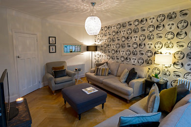 Photo of a medium sized eclectic living room in Essex with grey walls, medium hardwood flooring and a freestanding tv.