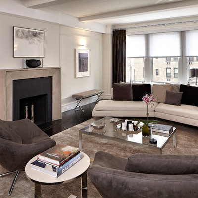 Example of a trendy living room design in New York with beige walls, a standard fireplace and no tv