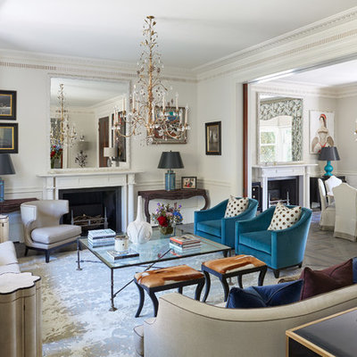 Example of a mid-sized transitional enclosed and formal light wood floor and gray floor living room design in London with white walls, a standard fireplace and no tv