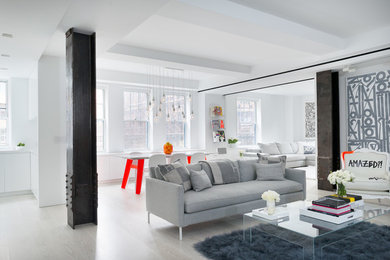 Photo of a contemporary open plan living room in New York with white walls, light hardwood flooring and beige floors.