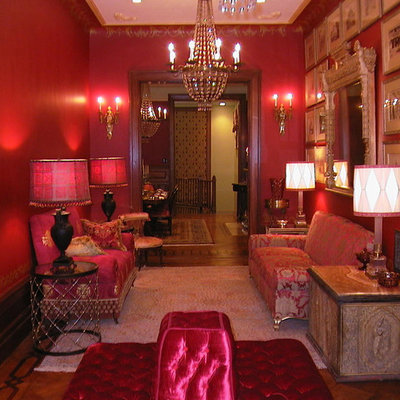 Living room - mid-sized traditional formal and enclosed medium tone wood floor and brown floor living room idea in New York with red walls, a standard fireplace and no tv
