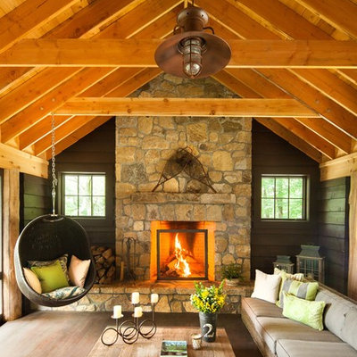 Mountain style living room photo in New York with a standard fireplace and a stone fireplace