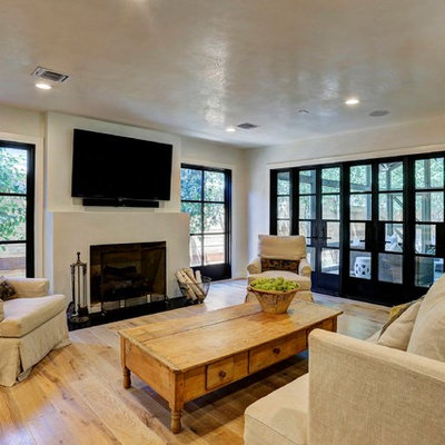 Example of a cottage open concept light wood floor living room design in Houston