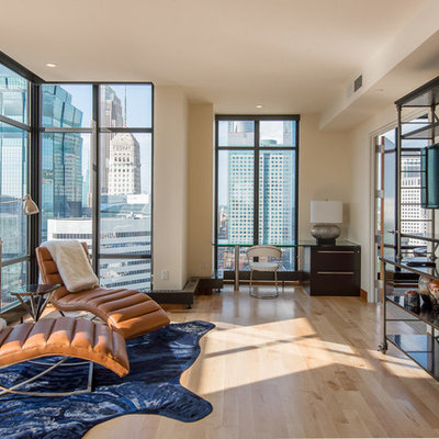 Inspiration for a mid-sized contemporary enclosed light wood floor living room remodel in Minneapolis with beige walls and a wall-mounted tv