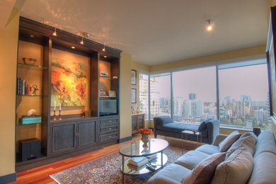 Mid-sized transitional formal and open concept medium tone wood floor and brown floor living room photo in Seattle with beige walls and a media wall