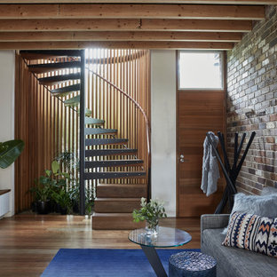 Photo of a mid-sized industrial open concept living room in Sydney with medium hardwood floors, brown floor and white walls.