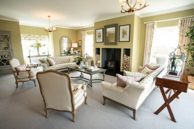 Inspiration for a large traditional formal enclosed living room in Other with yellow walls, carpet, a wood burning stove, a plastered fireplace surround and grey floors.