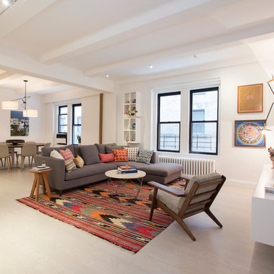 Example of a large trendy formal and open concept living room design in New York with white walls and a wall-mounted tv
