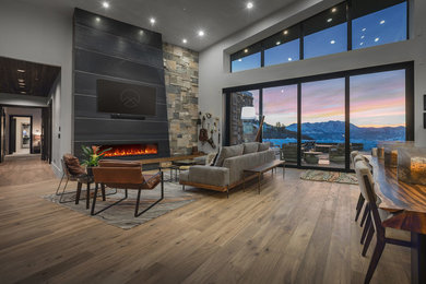 Example of a trendy open concept dark wood floor and brown floor living room design in Salt Lake City with gray walls, a ribbon fireplace and a wall-mounted tv