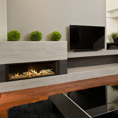 Living room - large modern open concept dark wood floor living room idea in Portland with gray walls, a ribbon fireplace, a tile fireplace and a wall-mounted tv