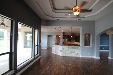 Example of a mid-sized open concept dark wood floor living room design in Austin with blue walls