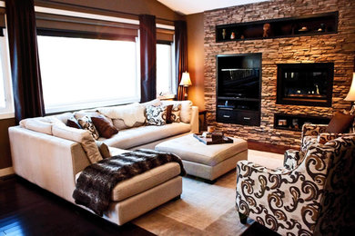 Elegant dark wood floor living room photo in Calgary with brown walls, a standard fireplace and a stone fireplace