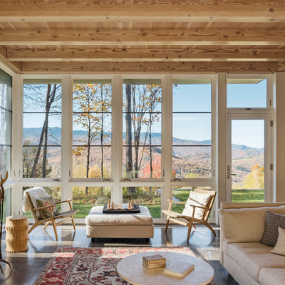 Inspiration for a mid-sized cottage open concept concrete floor and gray floor living room library remodel in Boston with a wood stove, a brick fireplace and no tv