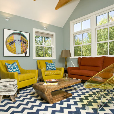 Example of an eclectic enclosed living room design in Other with blue walls