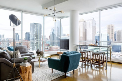 Стильный дизайн: гостиная комната в современном стиле с бетонным полом, отдельно стоящим телевизором и коричневым полом - последний тренд