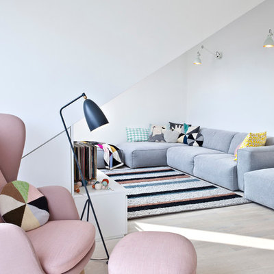 Living room - scandinavian formal light wood floor living room idea in Other with white walls