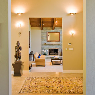 view from dining room across entry into living room with fireplace