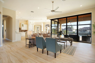 Example of a mid-sized island style formal and open concept porcelain tile and beige floor living room design in Miami with beige walls, no fireplace and no tv