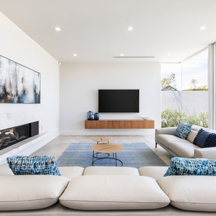 Contemporary living room in Adelaide with white walls, a ribbon fireplace, a wall-mounted tv and grey floor.