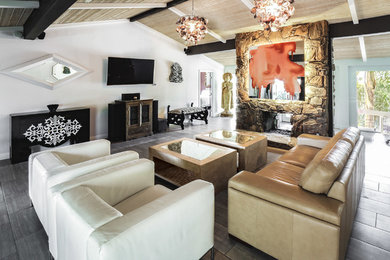 Large eclectic ceramic tile and gray floor living room photo in Los Angeles with a bar, white walls, a two-sided fireplace, a stone fireplace and a wall-mounted tv