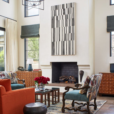 Example of a mid-sized trendy formal and open concept concrete floor and brown floor living room design in Phoenix with a standard fireplace, a brick fireplace, white walls and no tv