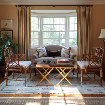 Example of a classic living room design in New York with beige walls