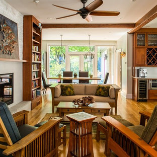 Example of an arts and crafts formal and open concept medium tone wood floor living room design in Atlanta