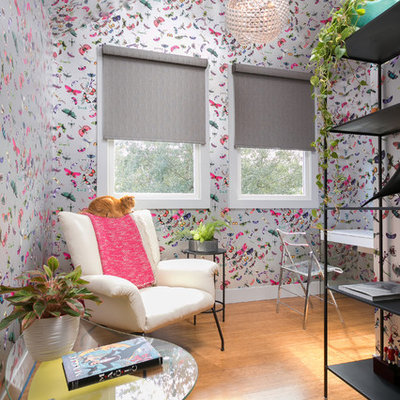 Inspiration for a mid-sized eclectic enclosed medium tone wood floor and brown floor living room library remodel in Charleston with multicolored walls, no fireplace and no tv