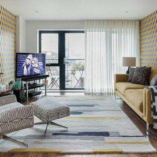 Medium sized retro enclosed living room in London with dark hardwood flooring, no fireplace, a freestanding tv, brown floors and multi-coloured walls.