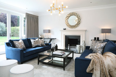 Photo of a medium sized classic formal enclosed living room in Surrey with a standard fireplace, a stone fireplace surround, no tv, grey floors, grey walls and carpet.