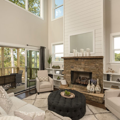 Cottage dark wood floor living room library photo in Other with beige walls, a ribbon fireplace, a stone fireplace and no tv