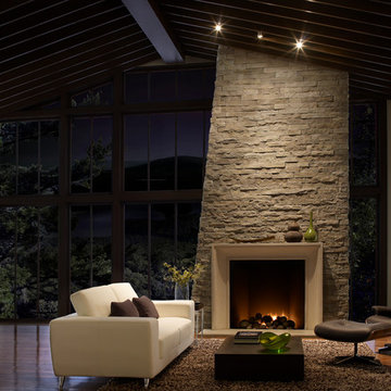 Warm Open Living Room With High Ceilings and Stone Fireplace