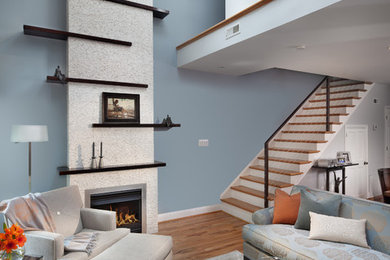 Living room - contemporary living room idea in Orange County with blue walls and a standard fireplace
