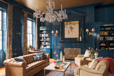 Идея дизайна: открытая гостиная комната в стиле неоклассика (современная классика) с синими стенами, стандартным камином и фасадом камина из камня