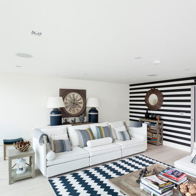 Danish loft-style light wood floor living room photo in Orange County with white walls