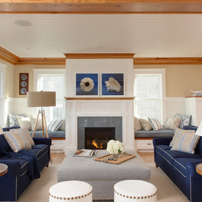 Example of a large beach style formal and open concept medium tone wood floor and beige floor living room design in Boston with beige walls, a standard fireplace, a stone fireplace and no tv