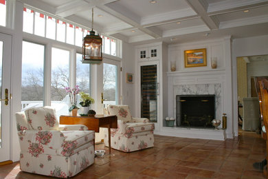 Traditional living room in New York with a standard fireplace and white walls.
