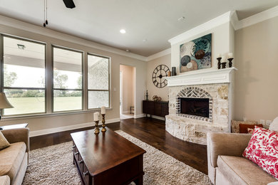 Mid-sized transitional open concept dark wood floor and brown floor living room photo in Dallas with beige walls, a standard fireplace and a stone fireplace