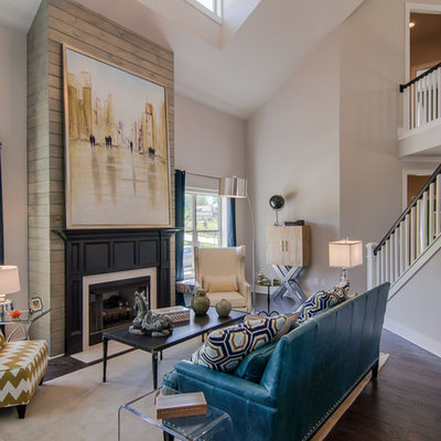 Example of a mid-sized trendy open concept and formal dark wood floor living room design in Birmingham with beige walls, a standard fireplace, a plaster fireplace and no tv