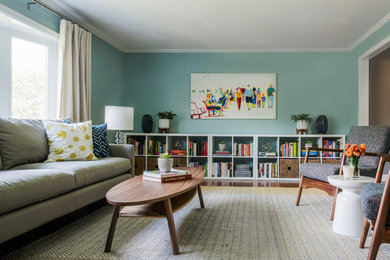 Design ideas for a medium sized retro enclosed living room in Boston with blue walls and light hardwood flooring.