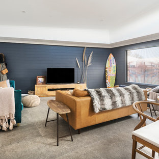 Mid-sized beach style open concept living room in Perth with ceramic floors, no fireplace, a freestanding tv, grey floor and blue walls.